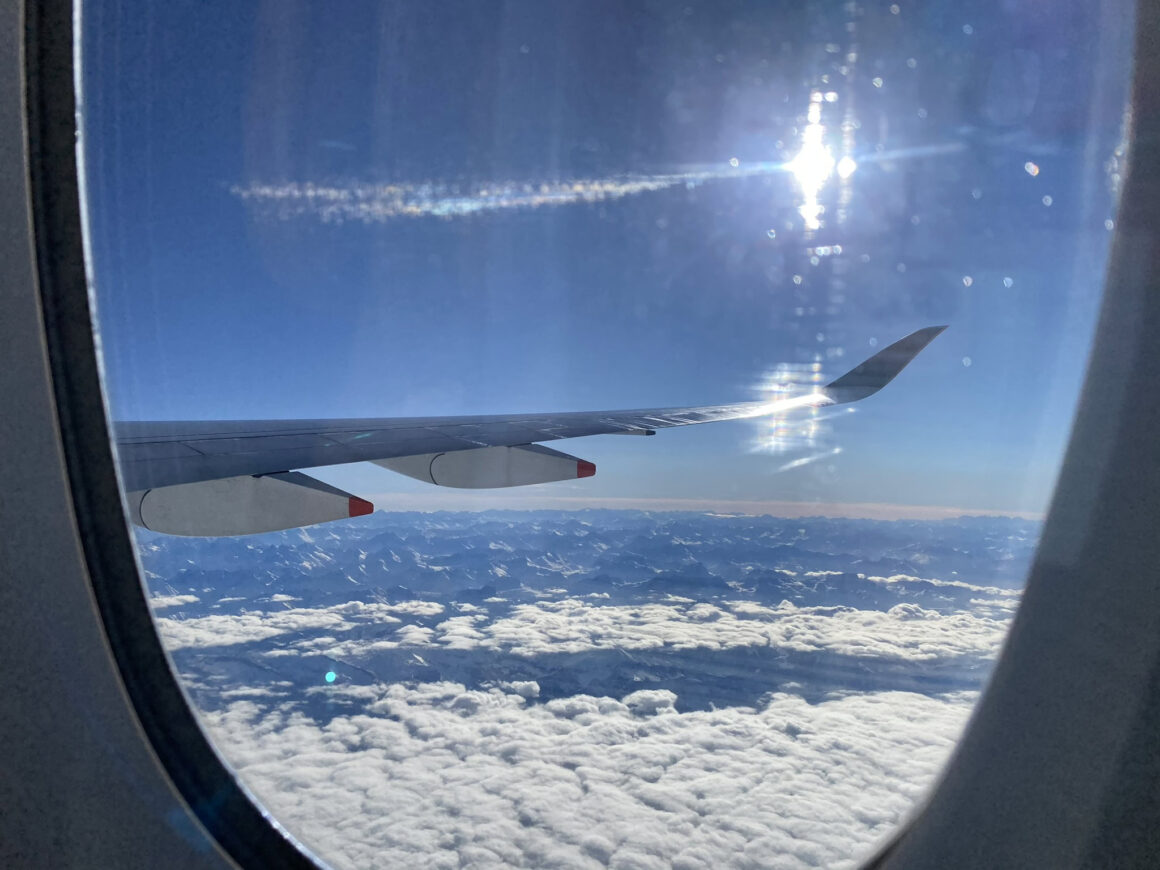 View from a plane window flying over the European Alps — heading home after a Rotary Youth Exchange year in Switzerland