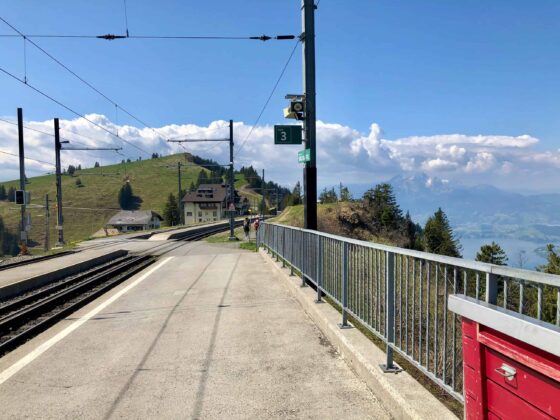A beautiful backdrop of the Swiss alps towers over Rigi Staffel Train Station on the way up to the summit of Mt Rigi.