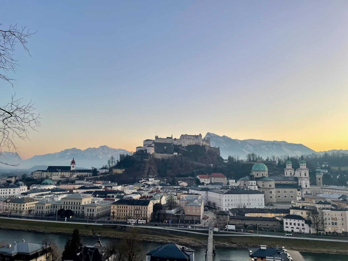 View of the old town of Salzburg, Fortress Hohensalzburg, and the alps — quintissential Europe