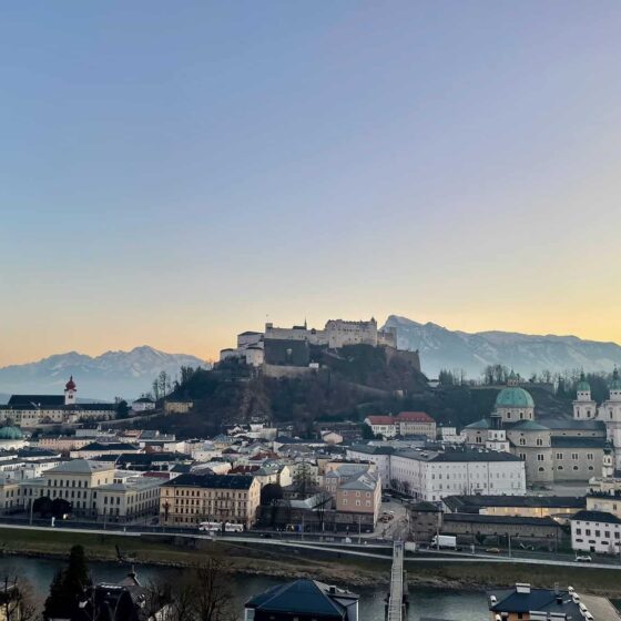 View of the old town of Salzburg, Fortress Hohensalzburg, and the alps — quintissential Europe