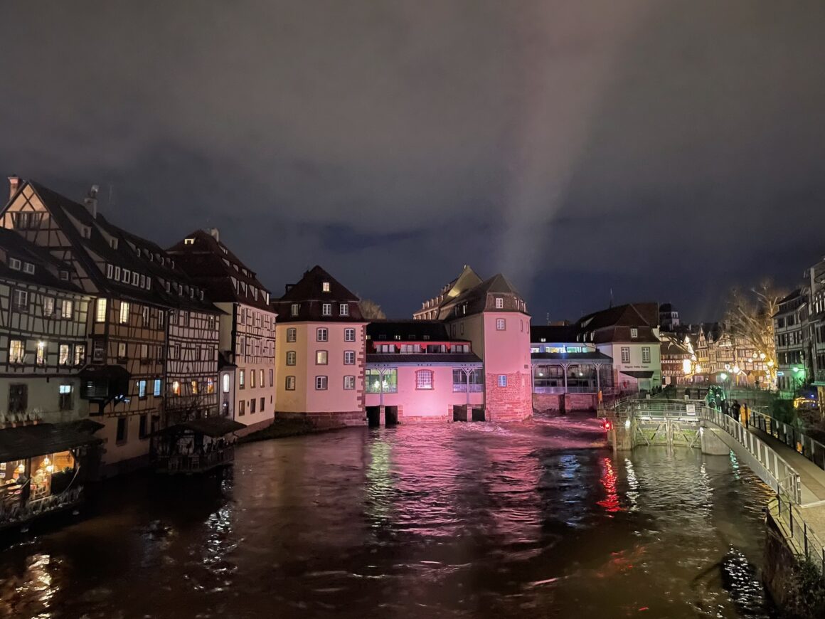 Half-timbered houses along the river in Strasbourg old town at night, France